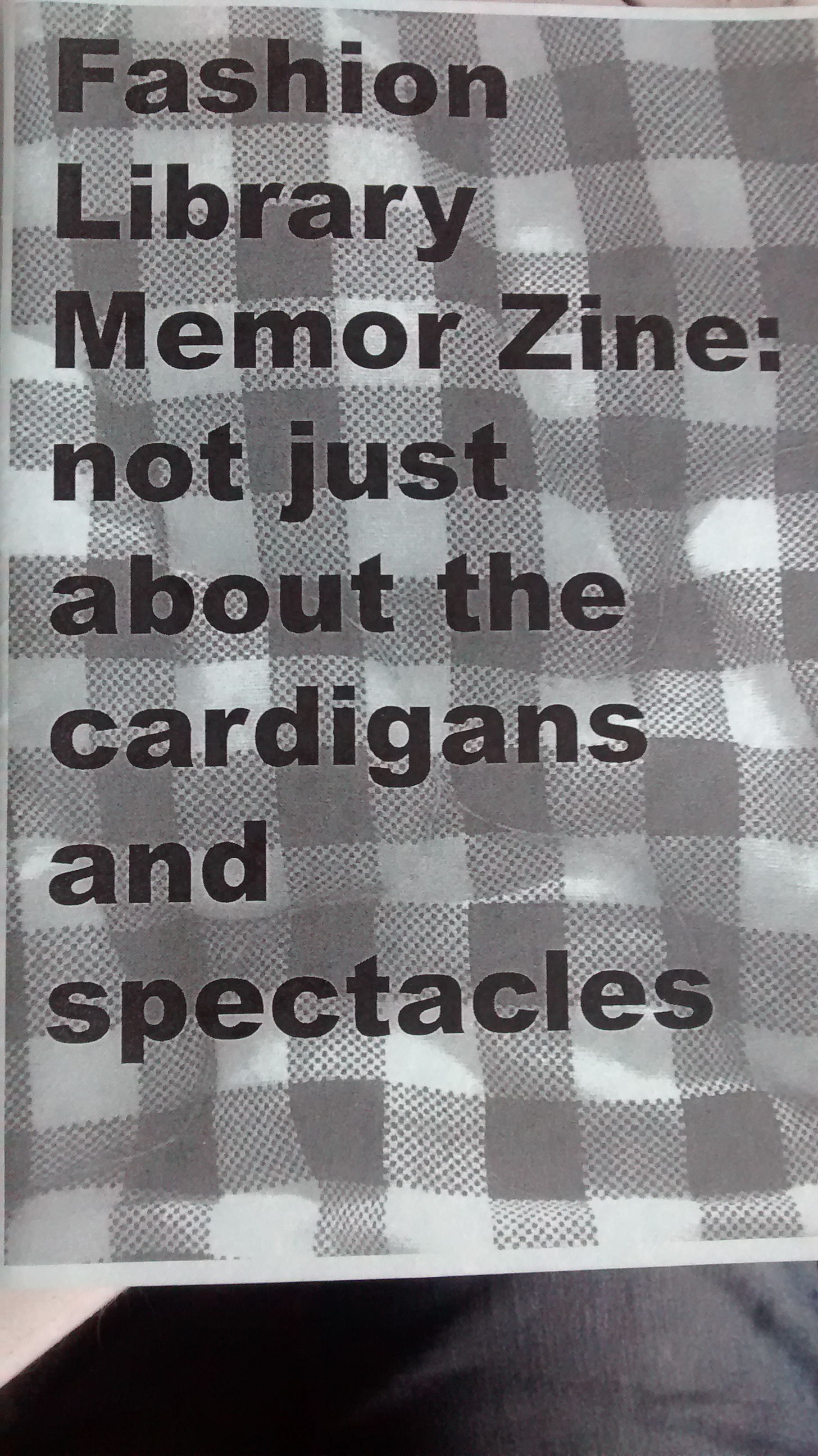 Title, "Fashion Library Memor Zine: not just about the cardigans and spectacles" printed over half-toned photograph of checkerboard tablecloth.