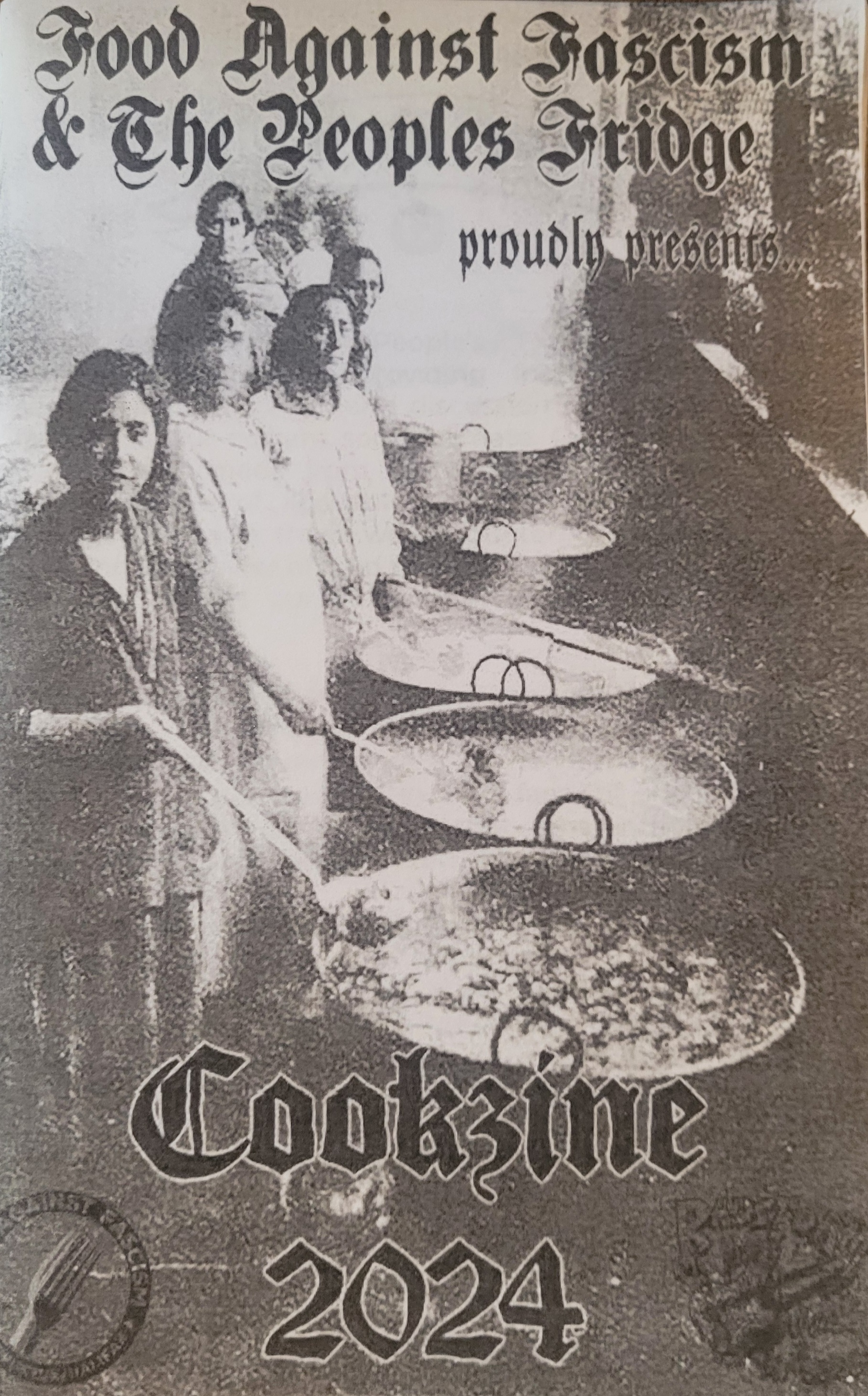 Old black and white photograph of people cooking giant pots of food.