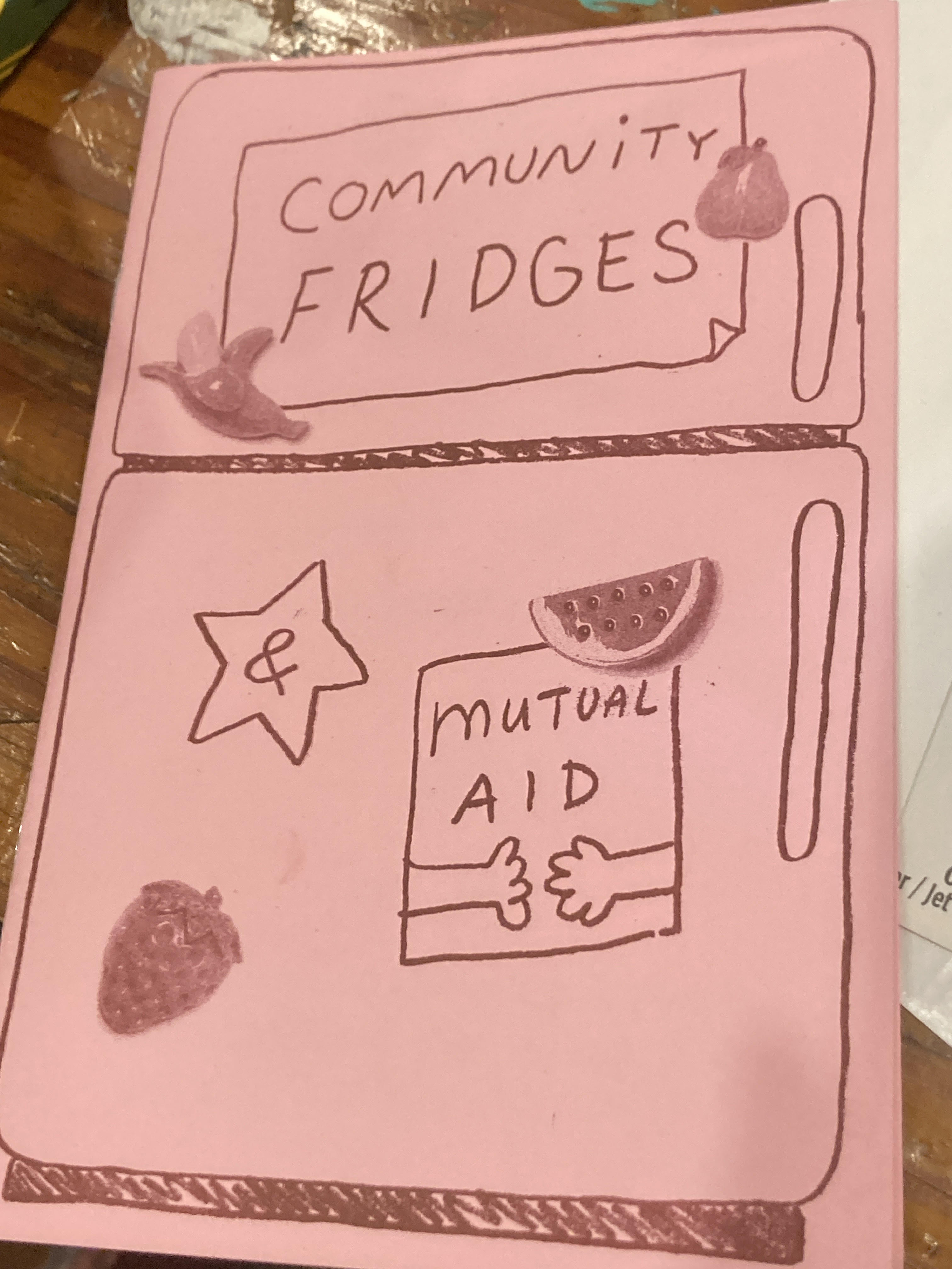 Cover of the zine Community Fridges & Mutual Aid, which has drawings of fruit and hands holding