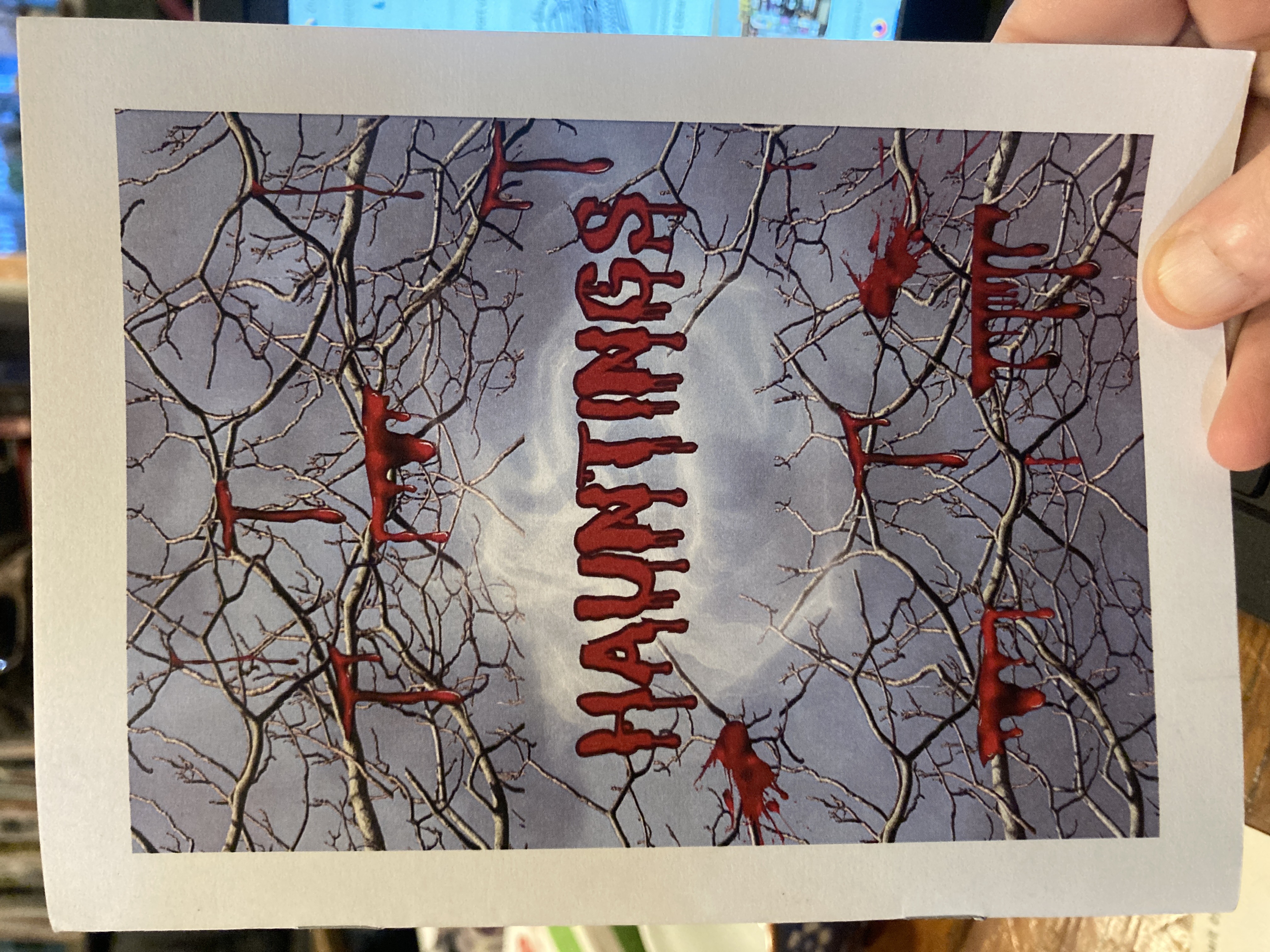 Cover of the zine Hauntings with a picture of tree branches dripping with blood
