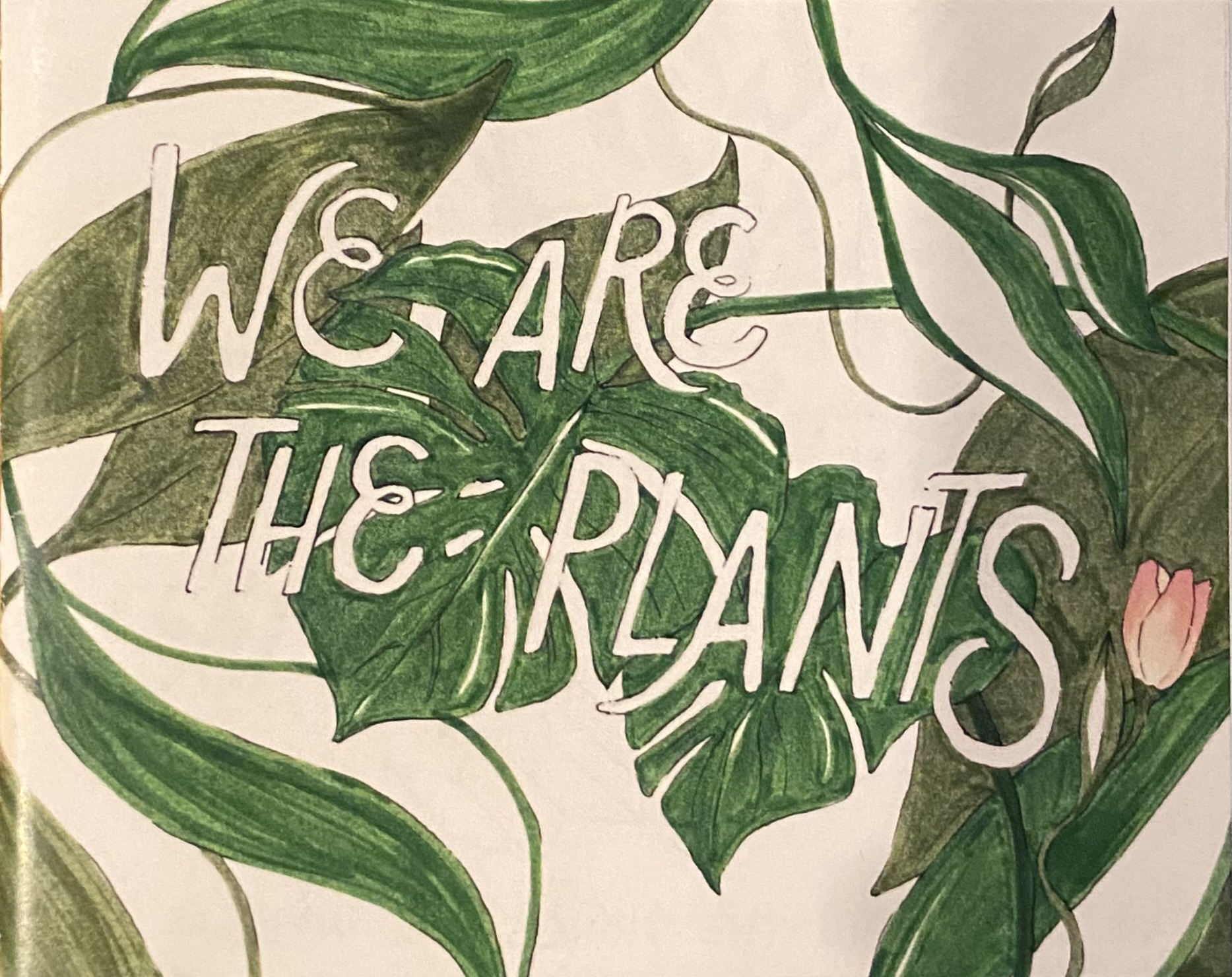 Title of zine "We Are The Plants" written in whitein all caps shrowded my plants.