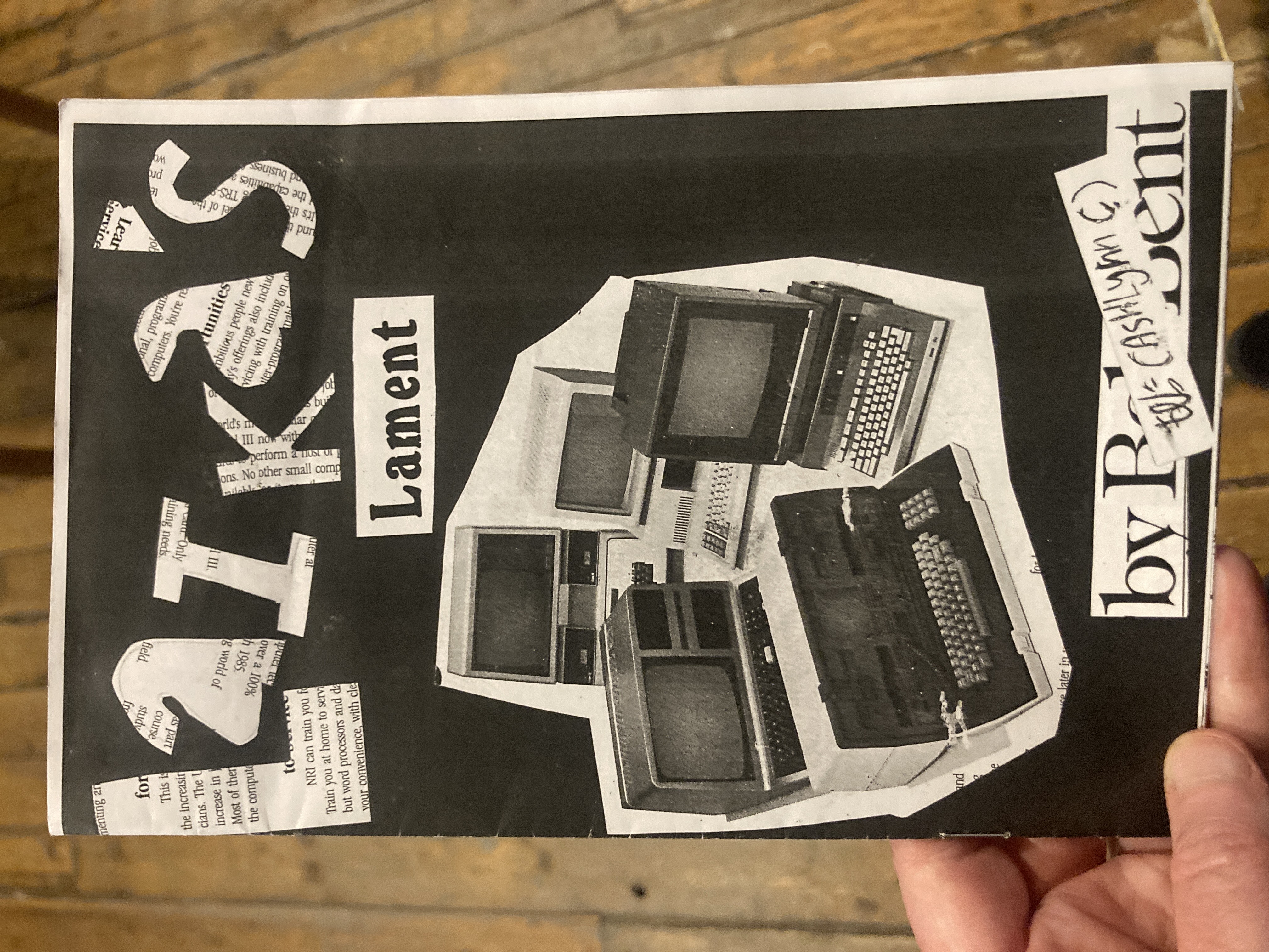 Cover of the zine "Laika's Lament," which has the letters of the title cut out of newsprint and a picture of computers from the 80s