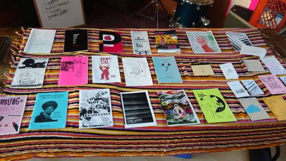 Image of a table displaying a selection of zines.